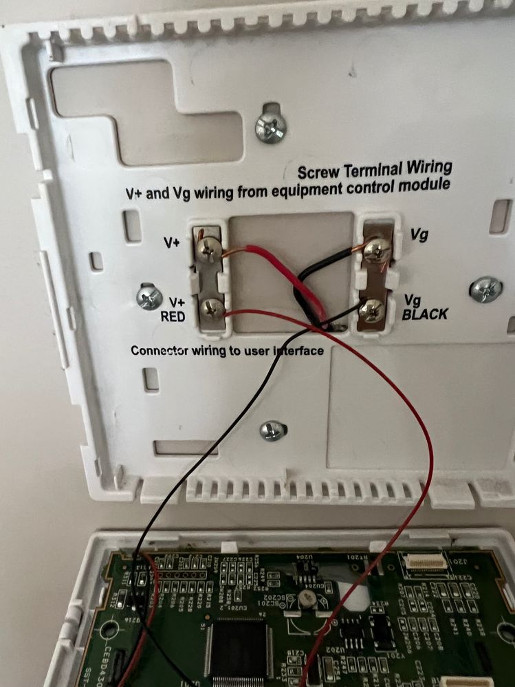 Inside Carrier thermostat showing only Red and Black wires connected from the furnace